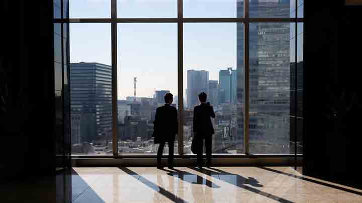 Businessmen are seen inside a high-rise office building in Tokyo November 21, 2013.