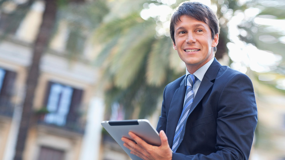 Businessman using digital tablet outdoors