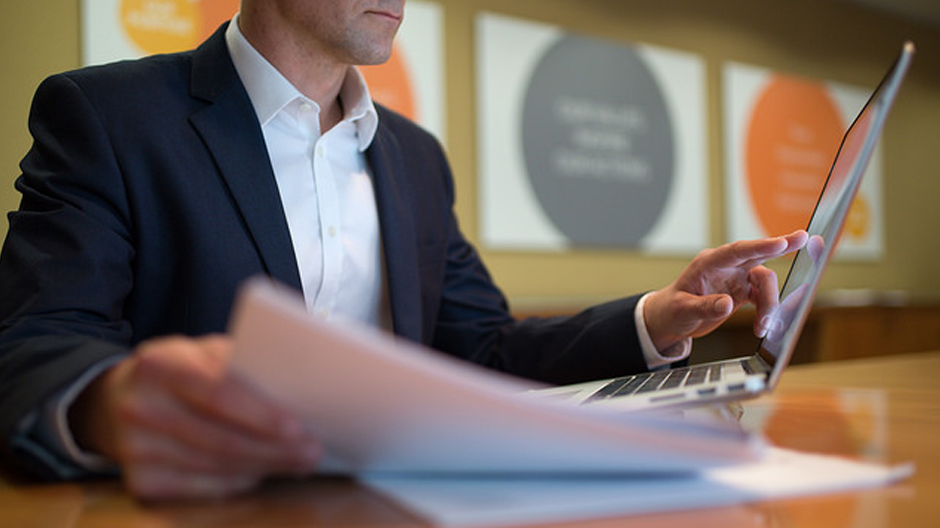 An office worker studies information on a computer